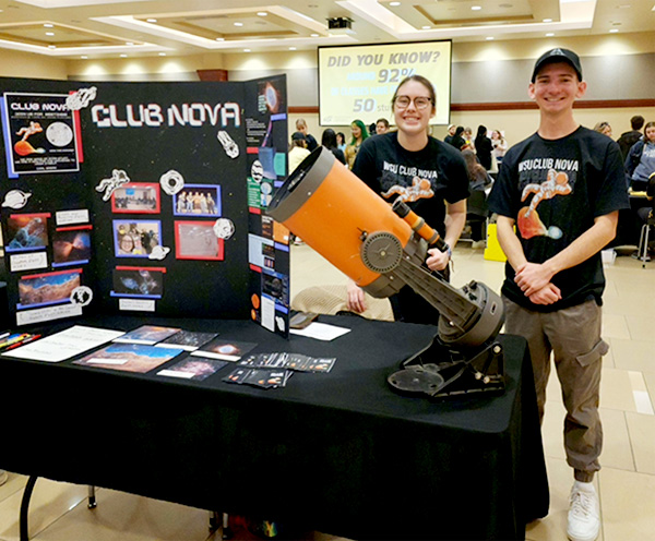Rory Mata tabling for Club Nova with a guy