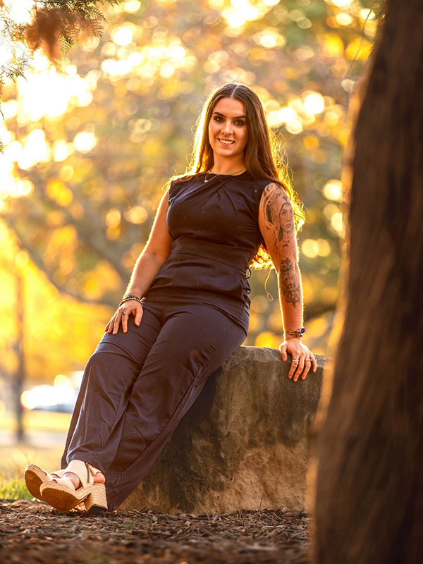 Bella Neish sits on a rock