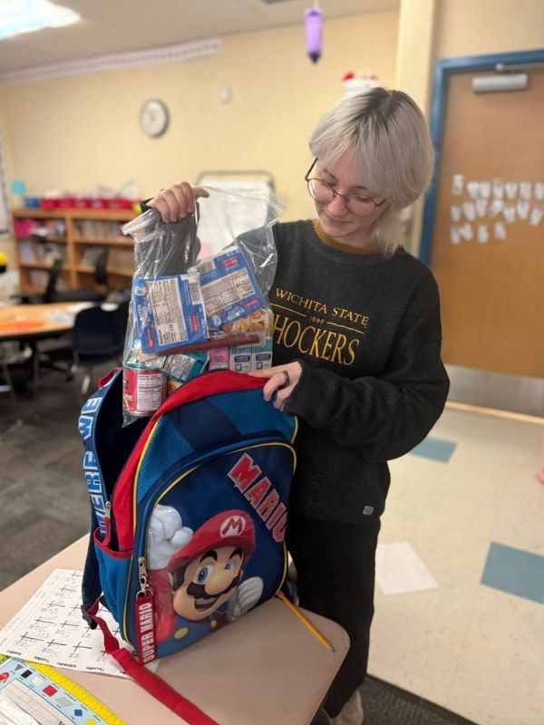 Kaydence Purdue holding a backpack