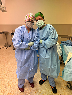 Mady in scrubs next to fellow student