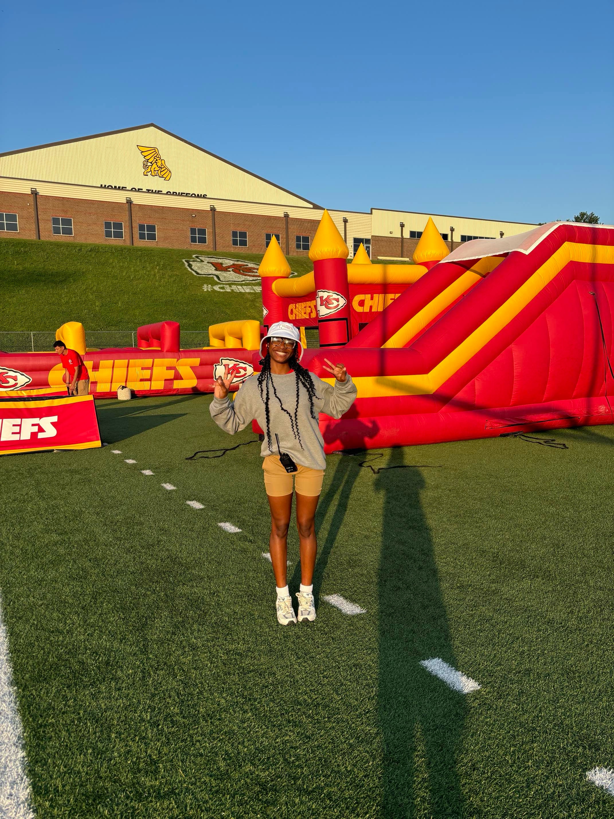 Ja'Nae McKelvy in front of Kansas City Chiefs bouncy house