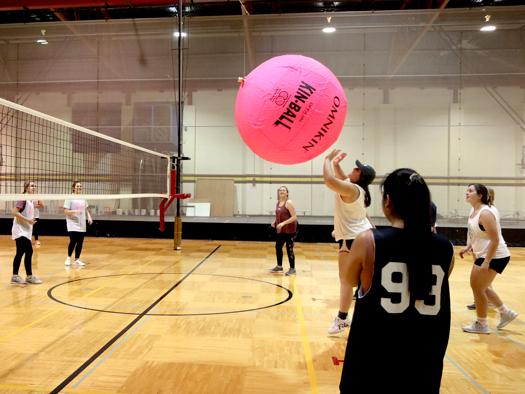 people playing big pink volleyball