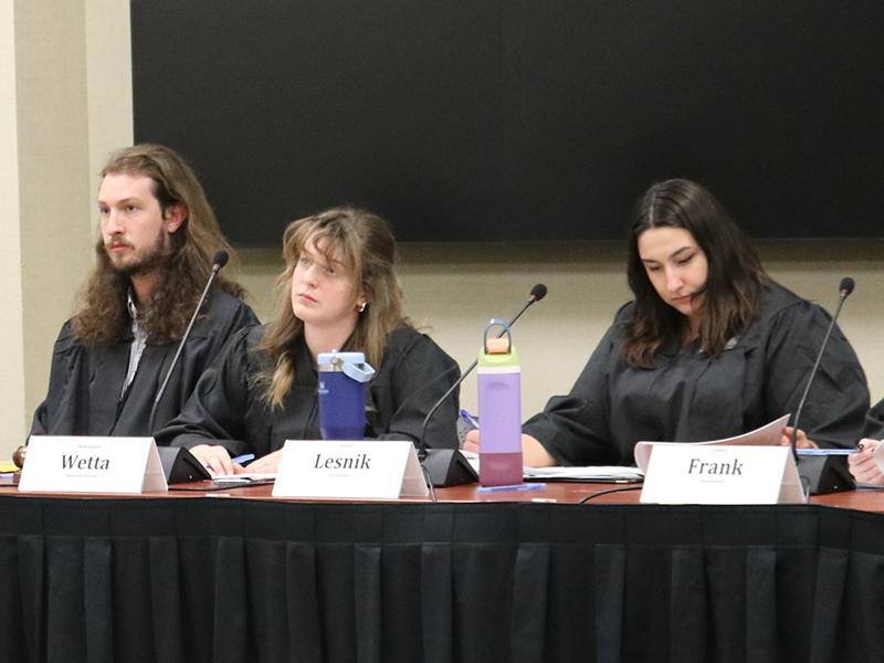 Three court justices listening to a case.