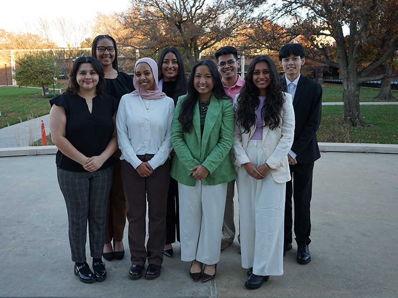 Group of students smiling for the camera outside of the RSC.