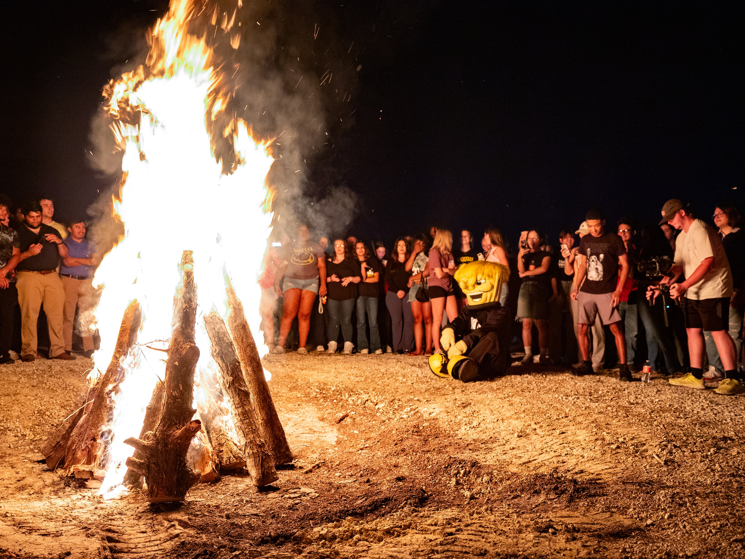 Students and WuShock gathered around a bonfire during Shocktoberfest.