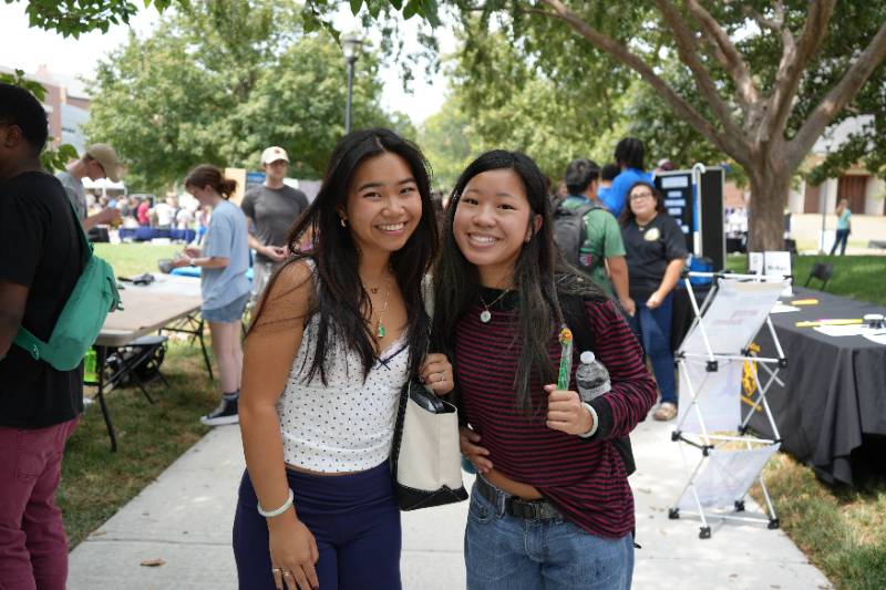 two girls standing for a picture for Involvement Fair