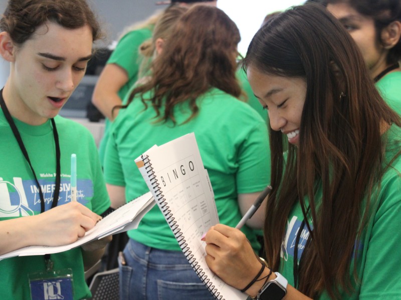 Two students playing human bingo