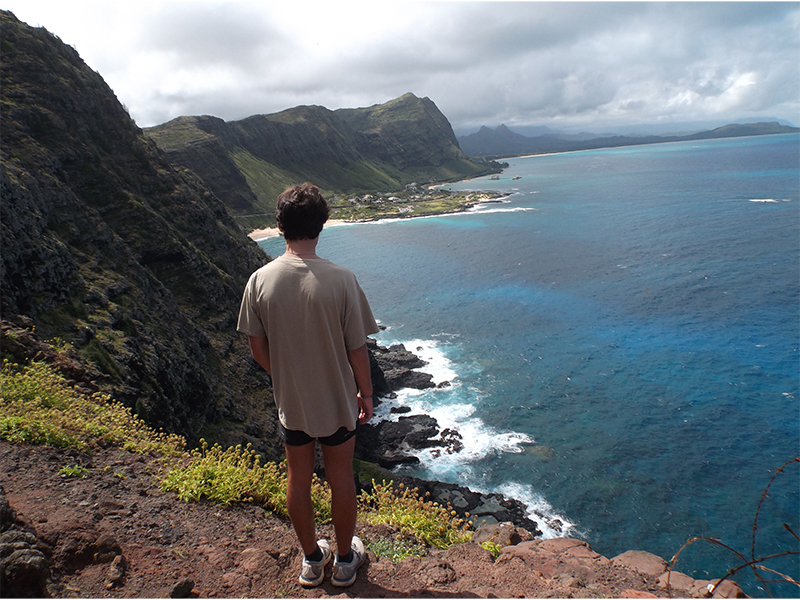NSE student standing over looking at the beach