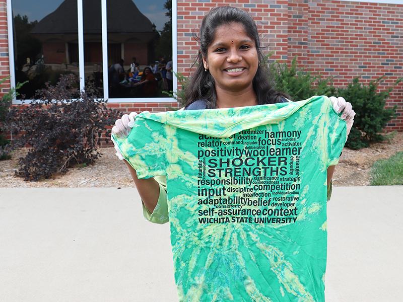 Student showing off their bleach dye t-shirt