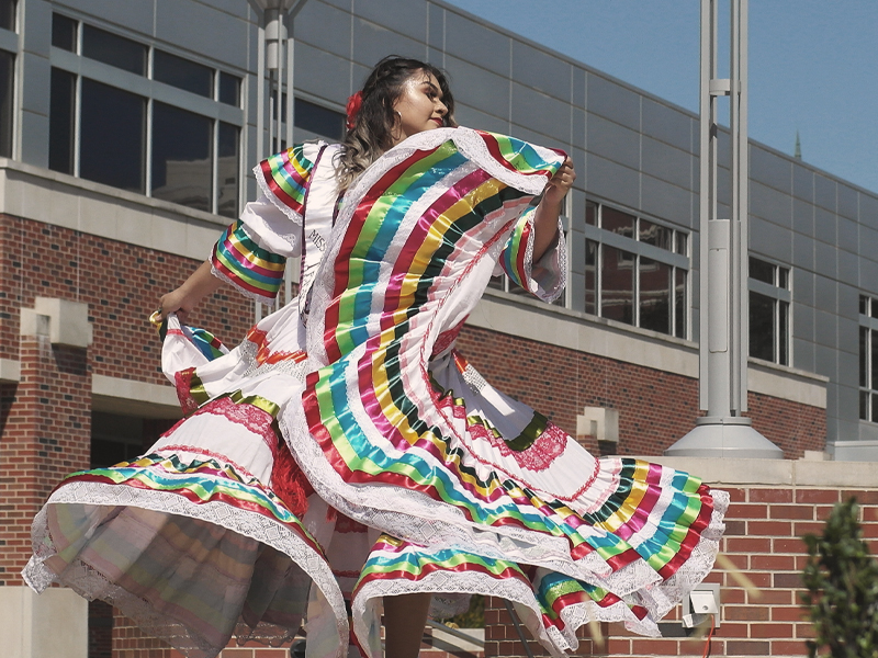 Folklore dancer performing during Latine Heritage Month Celebration event.