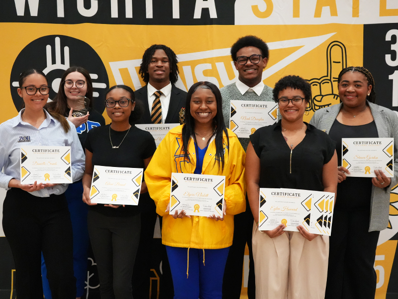 NPHC members pose for the camera with their awards and certificates.